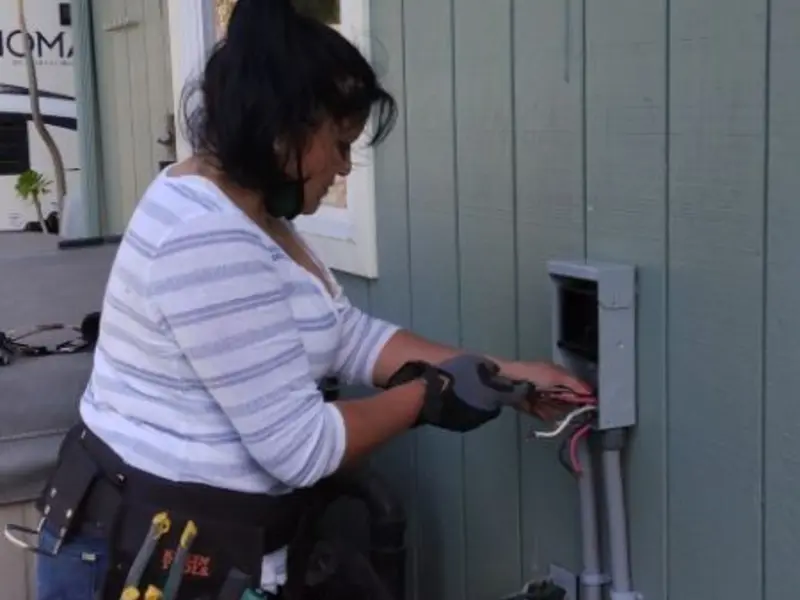 Licensed electrician wiring an exterior subpanel in Dillonvale